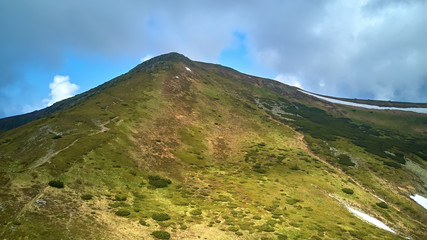 Mountain ridge with rocky outcrops. Panoramic view from the top of the ridge on background of...