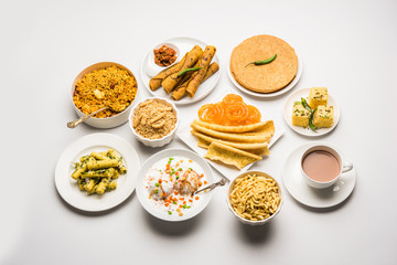 Group of Gujarati snacks like jalebi-fafda, thepla, khaman dhokla, aloo bhujiya, khandvi,khakra, dahi vada, gathiya with hot tea