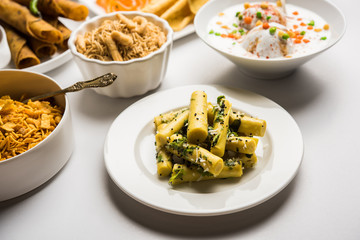 Group of Gujarati snacks like jalebi-fafda, thepla, khaman dhokla, aloo bhujiya, khandvi,khakra, dahi vada, gathiya with hot tea