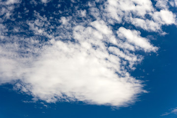 Naklejka na ściany i meble Beautiful clouds on a sunny day on the blue sky