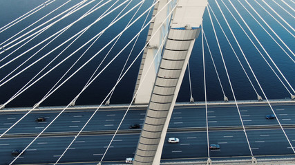 flycam moves above modern pylons of long cable-stayed bridge