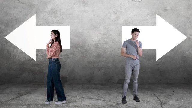 Confused two young people, walking back and forth while thinking together with arrow symbol background. Shot in 4k resolution
