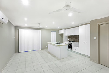 Fototapeta na wymiar Fully-furnished modular kitchen with white interiors
