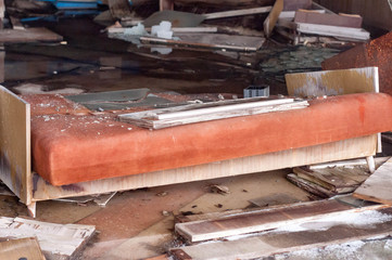 broken orange couch and other furniture in destroyed shop in Pripyt, Chernobyl zone of alienation