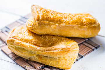 Fresh pastries on a white background close-up. Several rolls with filling on a white background