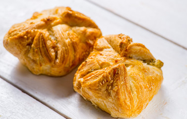 Fresh pastries on a white background close-up. Several rolls with filling on a white background