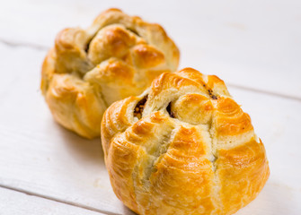 Fresh pastries on a white background close-up. Several rolls with filling on a white background