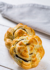 Fresh pastries on a white background close-up. Several rolls with filling on a white background