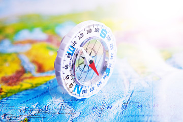 Compass on map. The magnetic compass is located on a geographic map. Satellites adventure. Travel concept.