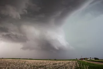 Fotobehang A wall cloud gathers under the base of a supercell storm in the great plains. © Dan Ross