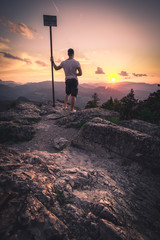 Obraz premium Man on top of mountain. Conceptual scene.
