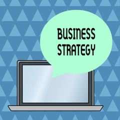 Fototapeta premium Text sign showing Business Strategy. Business photo showcasing Management game plan to achieve desired goal or objective Round Shape Empty Speech Bubble Floating Over Open Laptop Colored Backdrop