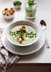 Green lunch for one person. Сream soup with green peas.Сucumber lemonade