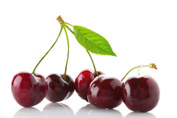 Fresh and ripe sweet cherry with green leaf close up