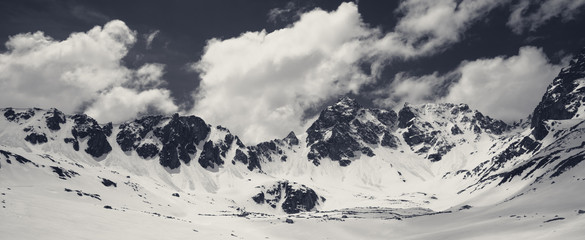Fototapeta na wymiar Black and white plateau in mountains and cloudy sky