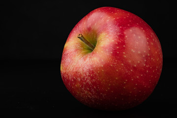 Tasty ripe apple on a dark table. Rich berries prepared to eat.