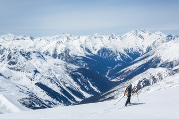 Skier traversing backcountry over the Asulkan Valley and Rogers Pass area of Glacier National Park, Canada.