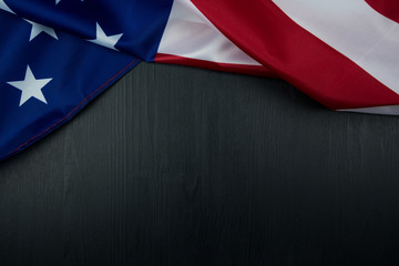 American flag on black wooden board. Top view with copy space.