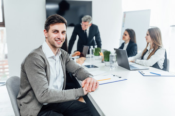 Portrait of smiling businessman working in office, looking camera..