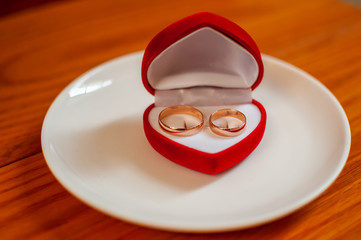 Pair of gold wedding rings in the red box