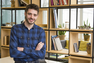 handsome student guy is looking at the camera and smiling