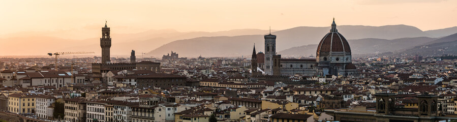 Fototapeta na wymiar Long panoramic view of Florence from Piazzale Michelangelo. Cityscape panorama with the Arno river, basilica, cathedral, Palazzo Vecchio