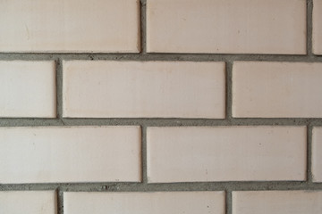 Light brown brick background. Beige wall.