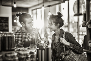 Beautiful young woman shopping in a bulk food store