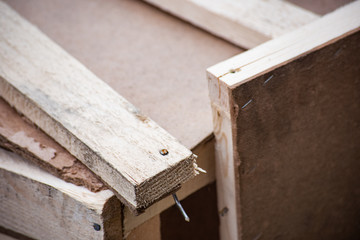 Damaged box of wooden boards with nails