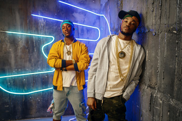 Obraz na płótnie Canvas Two black rappers, neon lights on background