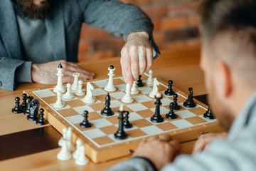 Male chess players playing, thinking process