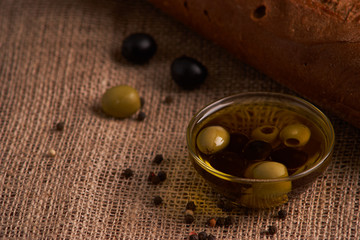 Fresh Italian baguette on wooden table with oil.Selective and soft focus