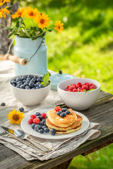 Sweet pancakes for breakfast in summer garden