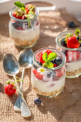 Oat flakes in jar with yoghurt and berries