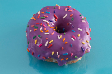 Purple Glazed Donut with Rainbow Sprinkles on Top