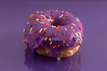 Purple Glazed Donut with Rainbow Sprinkles on Top