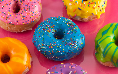 Batch of Rainbow Colored Glazed Donuts