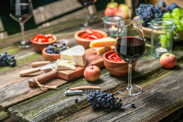 Closeup of supper with appetizers and wine on wooden table