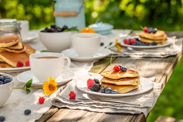 Fresh pancakes for breakfast in summer garden