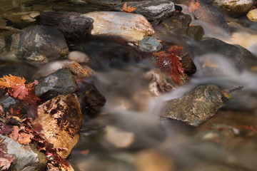 seaside with many rock, long exposure. long exposure of sea and rocks, aegean sea. ong exposure of stream and stony river
