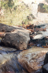 seaside with many rock, long exposure. long exposure of sea and rocks, aegean sea. ong exposure of stream and stony river