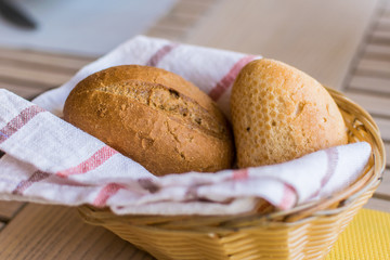 Two buns in a basket on the table in the restaurant.