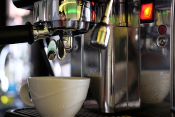 maker pouring coffee in cup
