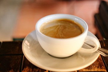cup of coffee on wooden table