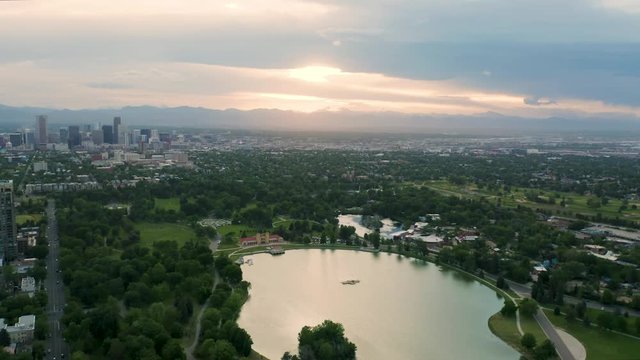 4k Aerial drone footage - Skyline of Denver Colorado at sunset from City Park.  Rocky Mountains on the horizon