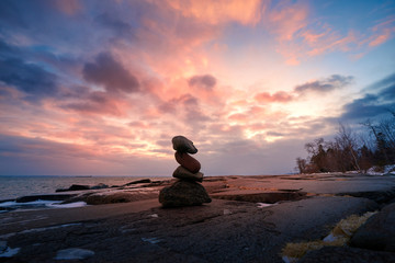 Zen Stone Stacking on rocks during sunset