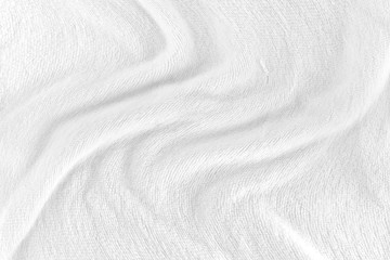 White fabric texture background with soft waves. selective focus