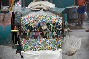 Recycle plastic bottle stack to conveyor line . Plastic recycling industry is recovering scrap or waste plastic from recycle bin to useful products. pile of reused the bin material for manage ecology.