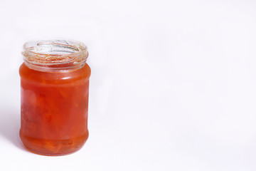 Glass jar of jam on a white background
