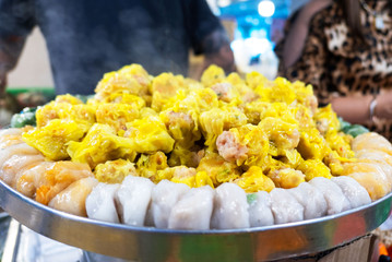 closeup yellow dumplings with chicken meat and vegetables , Dim sum .